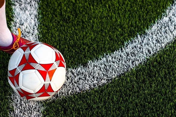 A footballer preparing to cross a ball into the penalty box