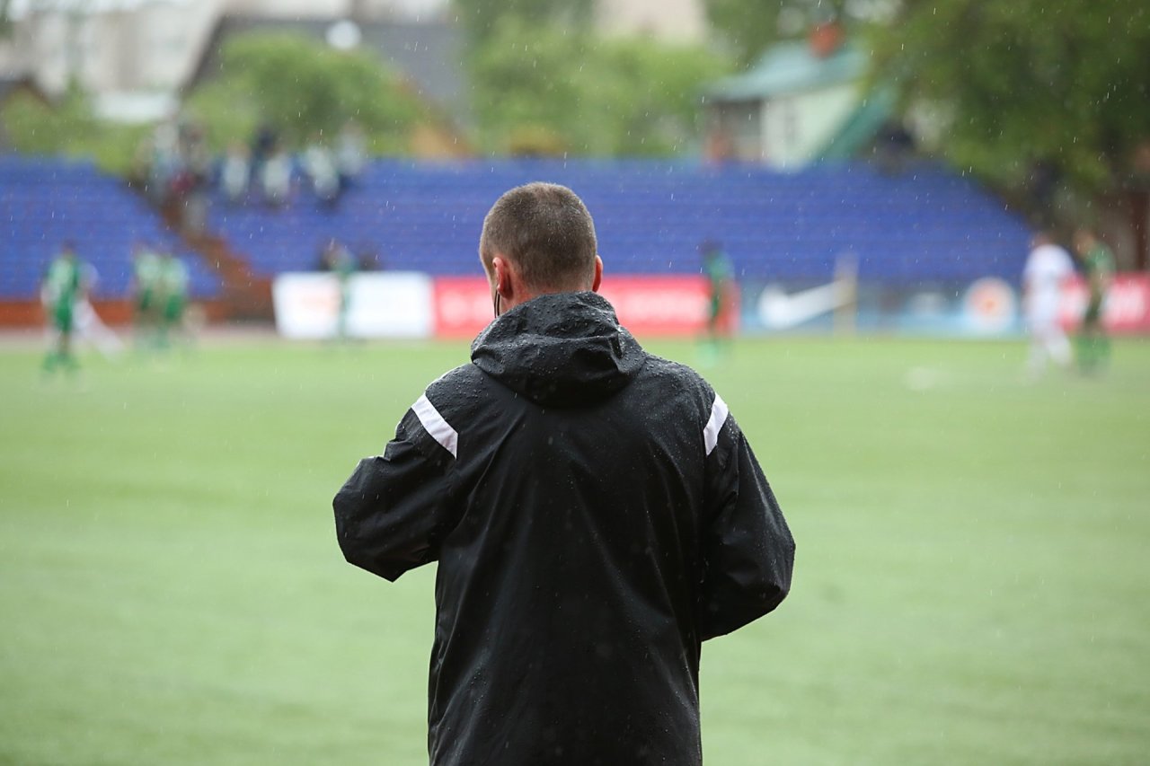 Football coach watching a match