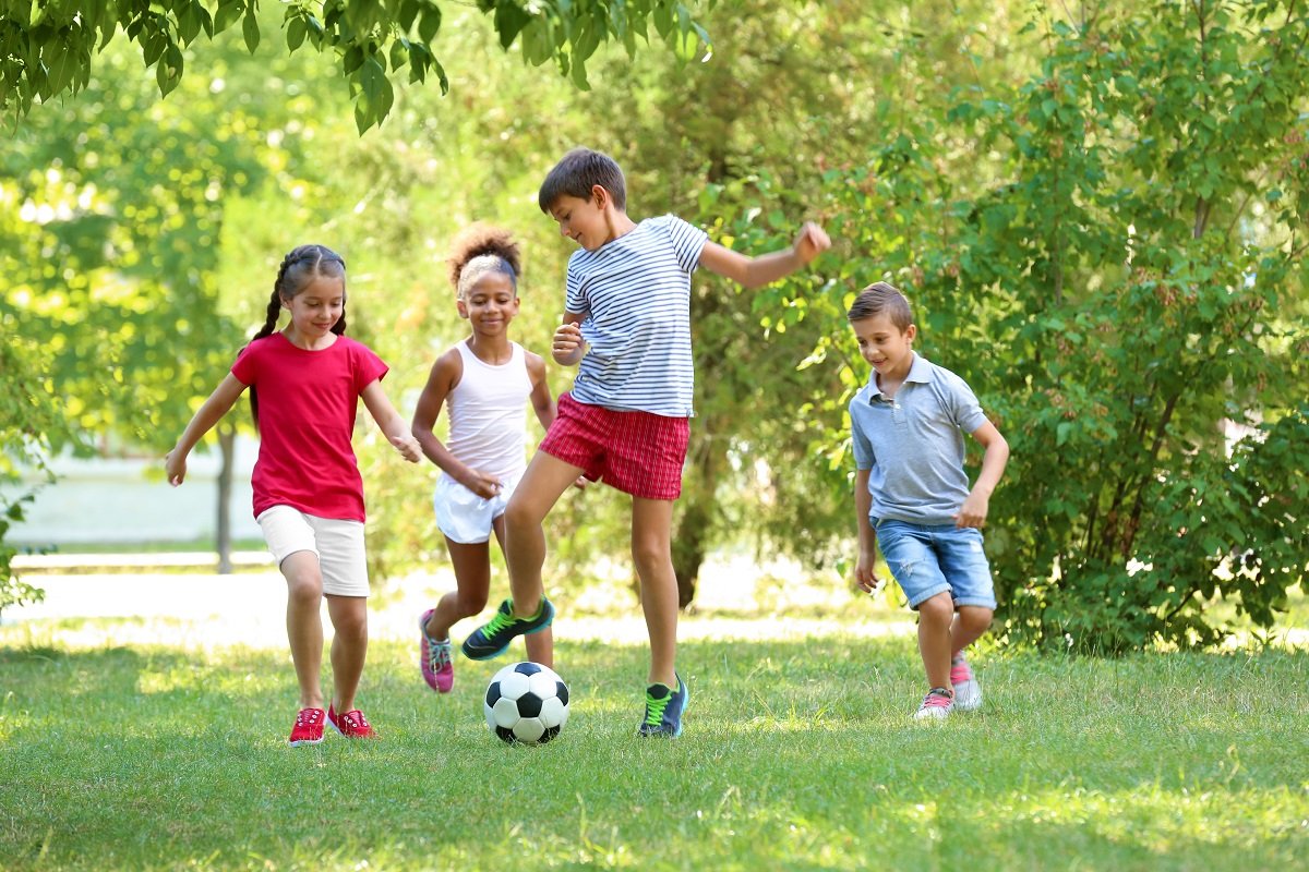 Children playing football in the park