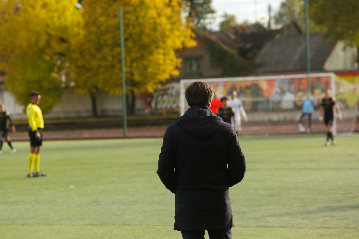 Football coach on pitch