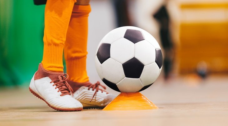 A football cone with a football on top of it