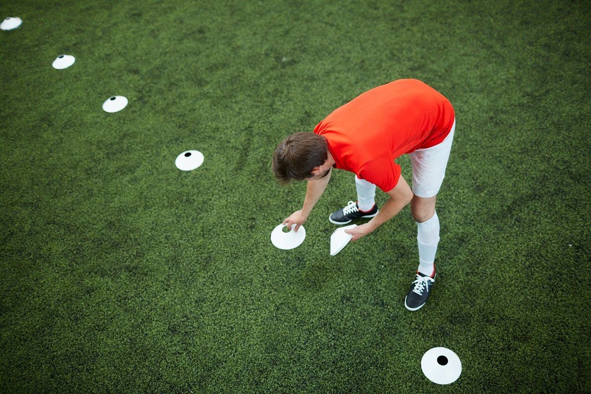 Football player laying down cones