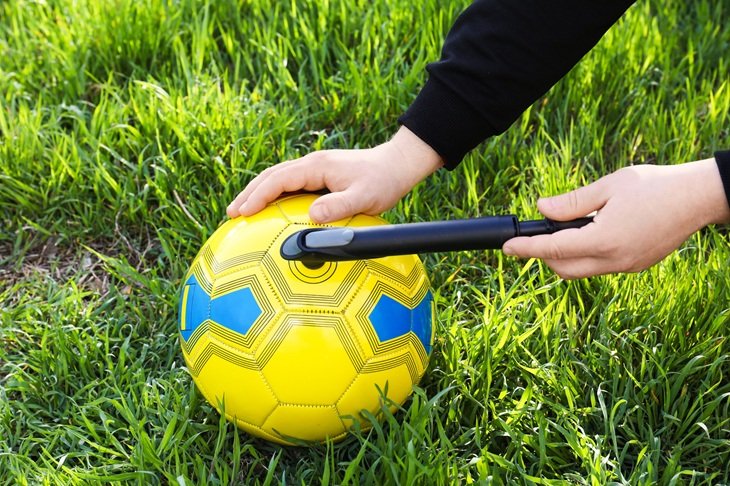 A man inflating a football