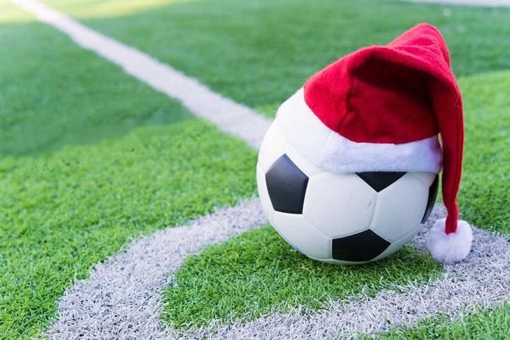 A football with a Santa hat on