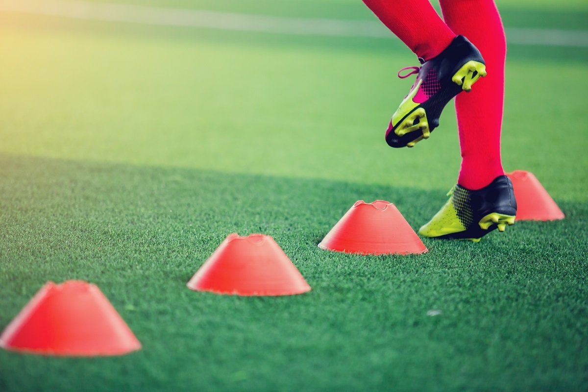 Footballer training with cones