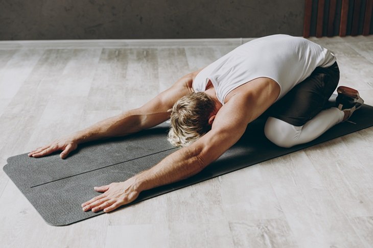A man in the middle of a yoga pose