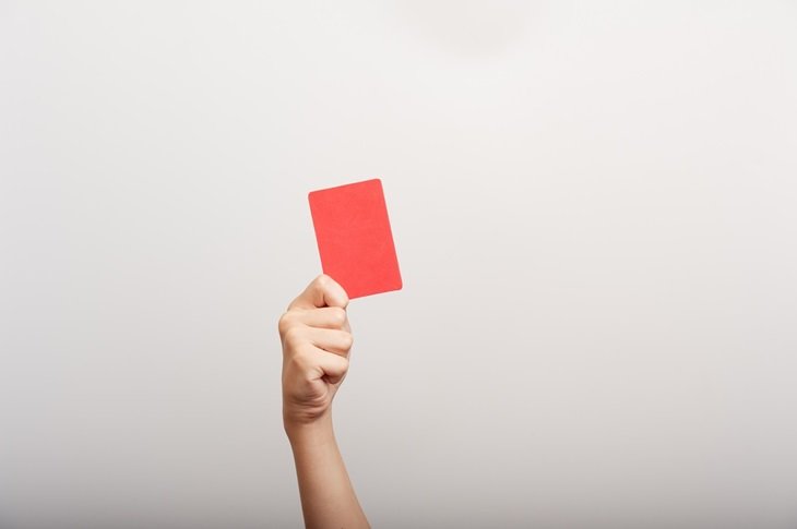 A red card being held up