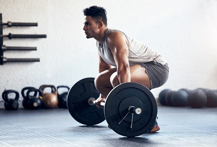 A man about to deadlift some weights